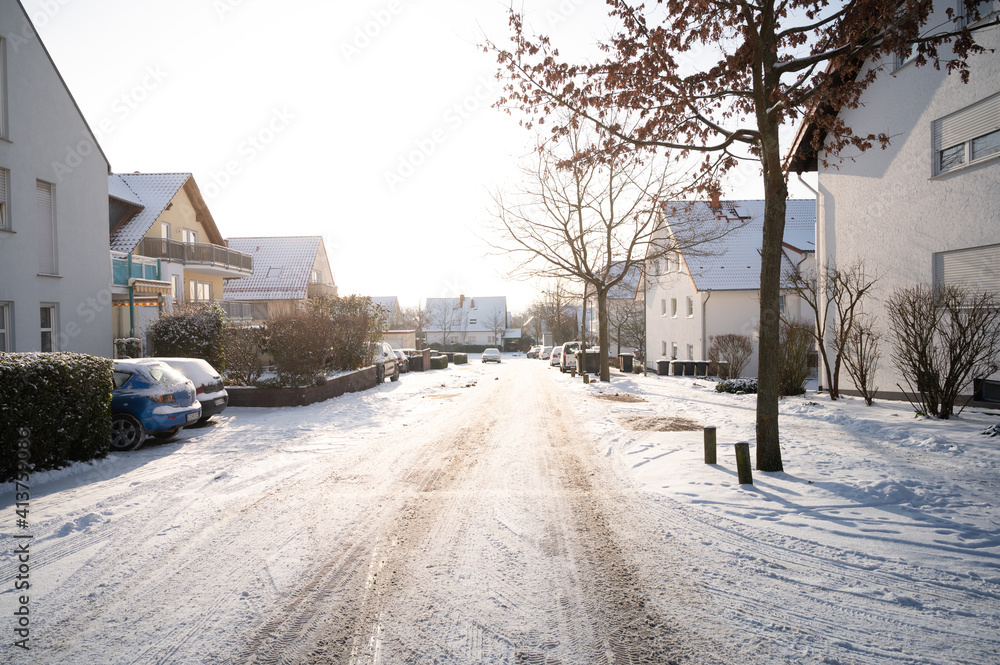 street in winter with snow and warm sun rays street in winter with snow and warm sun rays