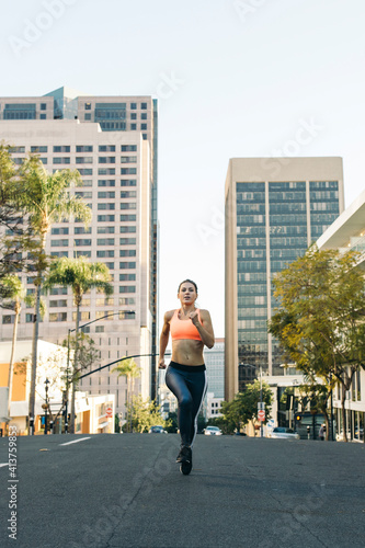 Wallpaper Mural Full length of determined female athlete running on city street Torontodigital.ca