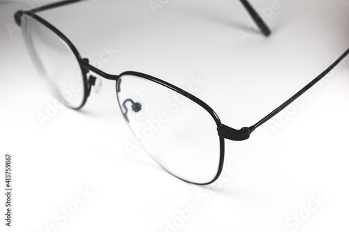 Black frame glasses on a white background. Close up photo.