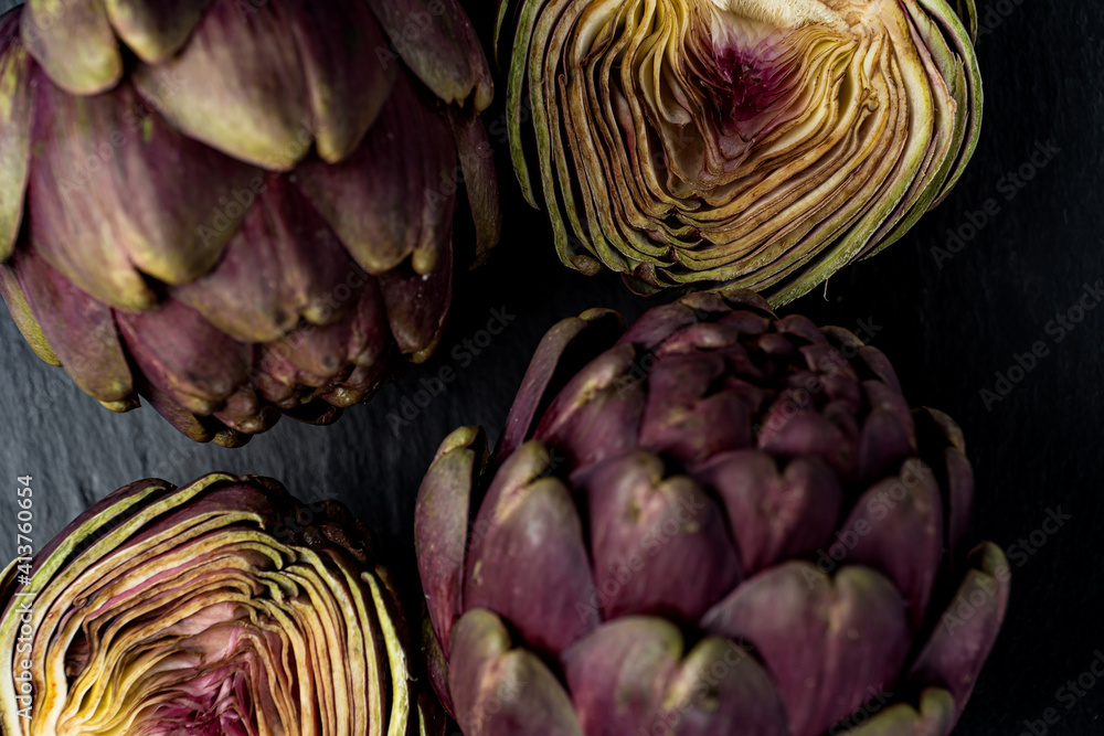 Fototapeta premium fresh artichokes close-up on dark gray background