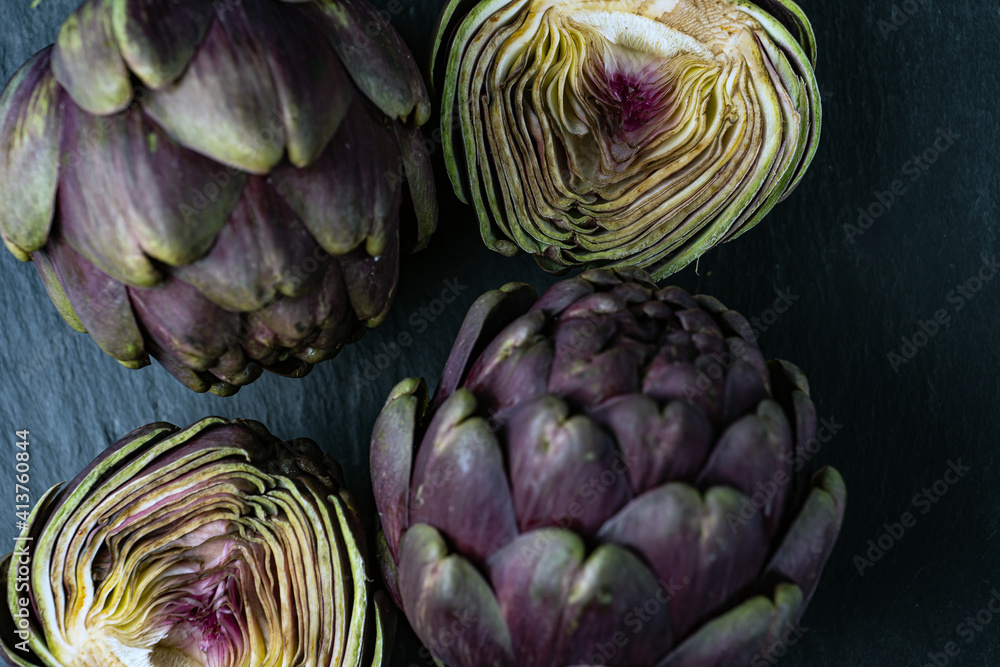 Fototapeta premium fresh artichokes close-up on dark gray background