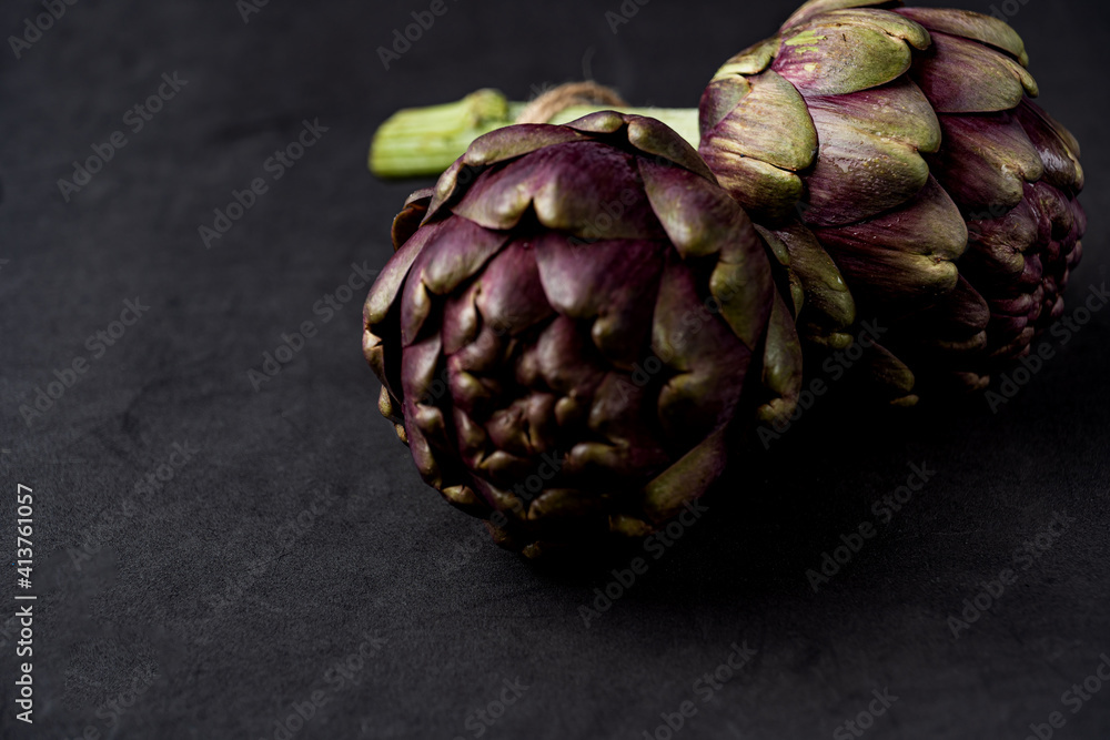 Fototapeta premium fresh artichokes close-up on dark gray background