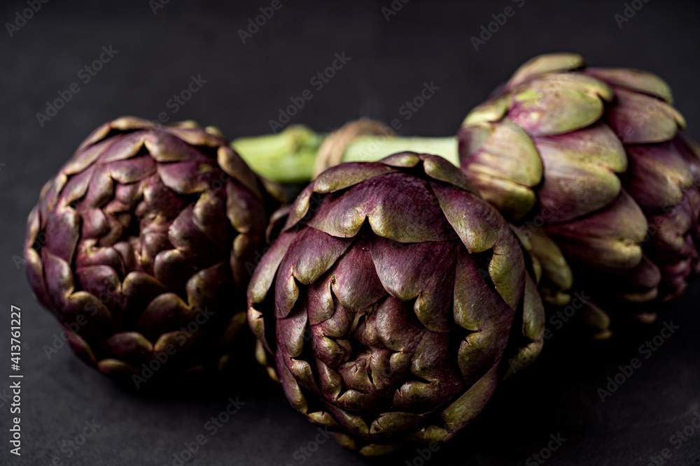 Obraz premium fresh artichokes close-up on dark gray background