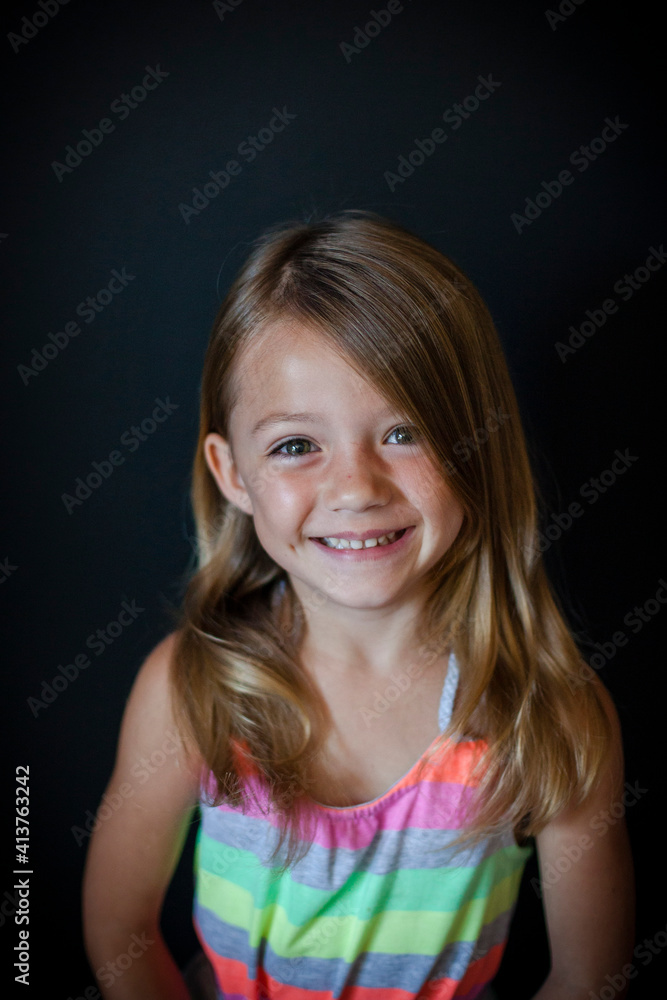 Portrait of happy girl standing against wall at home Portrait of happy girl standing against wall at home