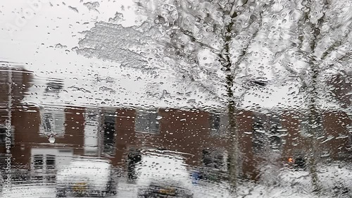 Cockpit view. Ice melts on the windshield of the car. Car wipers cleans the car windshield photo