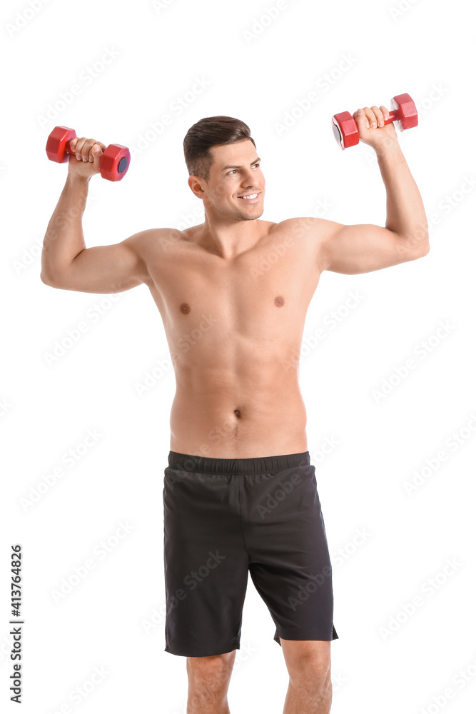 Sporty young man training with dumbbells on white background