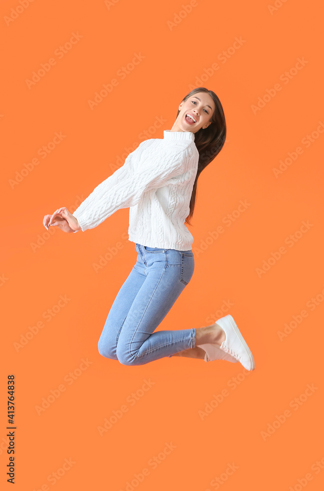Jumping young woman against color background Jumping young woman against color background