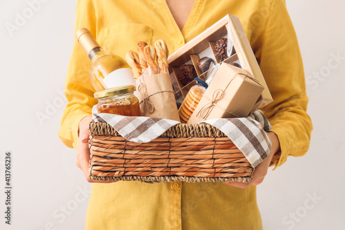 Woman holding gift basket w...
