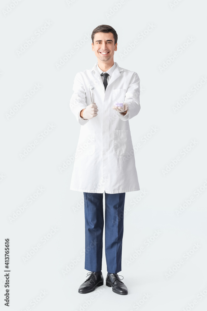 Male dentist on light background Male dentist on light background