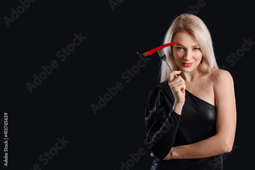 Sexy young woman with chili...