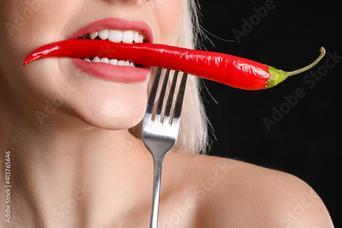 Sexy young woman with chili...