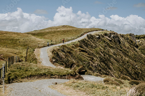 Hiking trail follows cliffs near Cap Foulwind, New Zealand photo