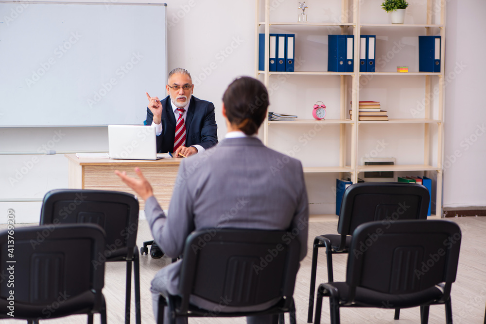 Two businessmen in the classroom in pandemic concept Two businessmen in the classroom in pandemic concept