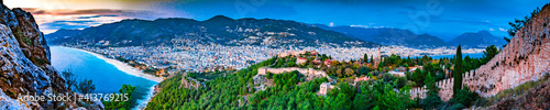 Aerial panorama of Alanya, Turkey with castle, mountains, city and coastline, blue hour at night © adammachowiak