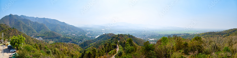 View of picturesque haze valley of the Kok River and Thai border town of Tha Ton from the hill top close to Wat Tha Ton. The Mekong tributary flows through the highlands of Northern Thailand.