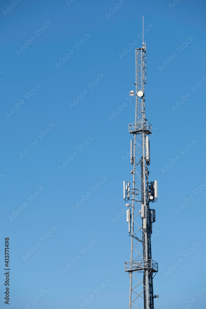 Top of a transmission tower for radio and television at blue sky Top of a transmission tower for radio and television at blue sky