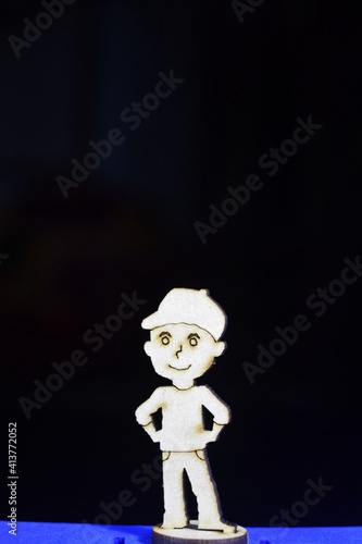 An wooden boy shape toy standing