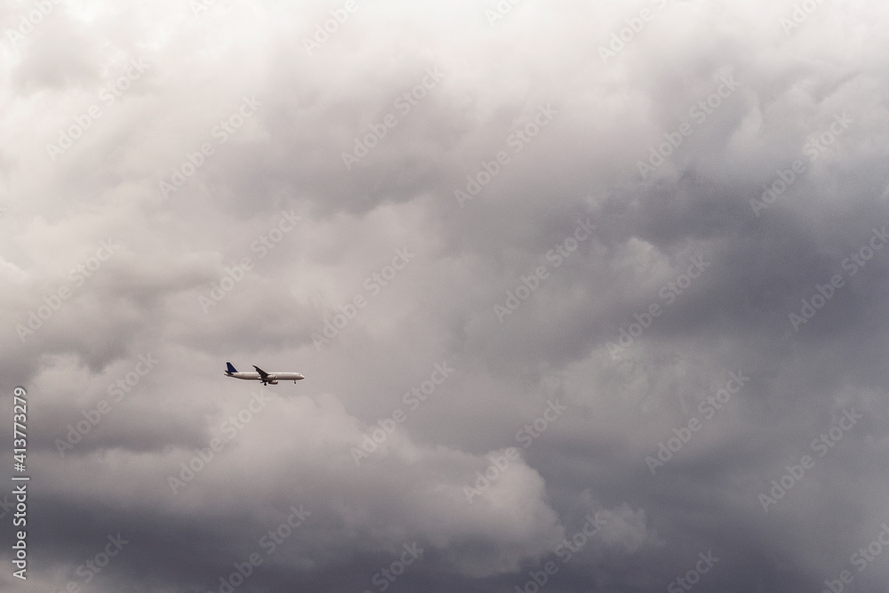 Low angle view of airplane flying in cloudy sky Low angle view of airplane flying in cloudy sky