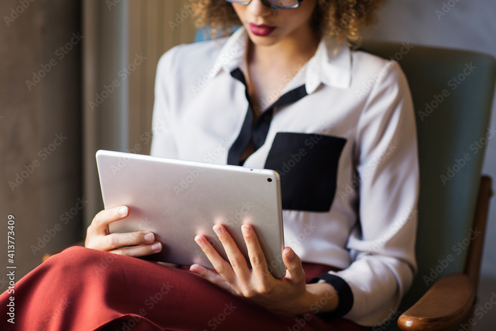 Midsection of businesswoman using tablet computer at hotel lobby