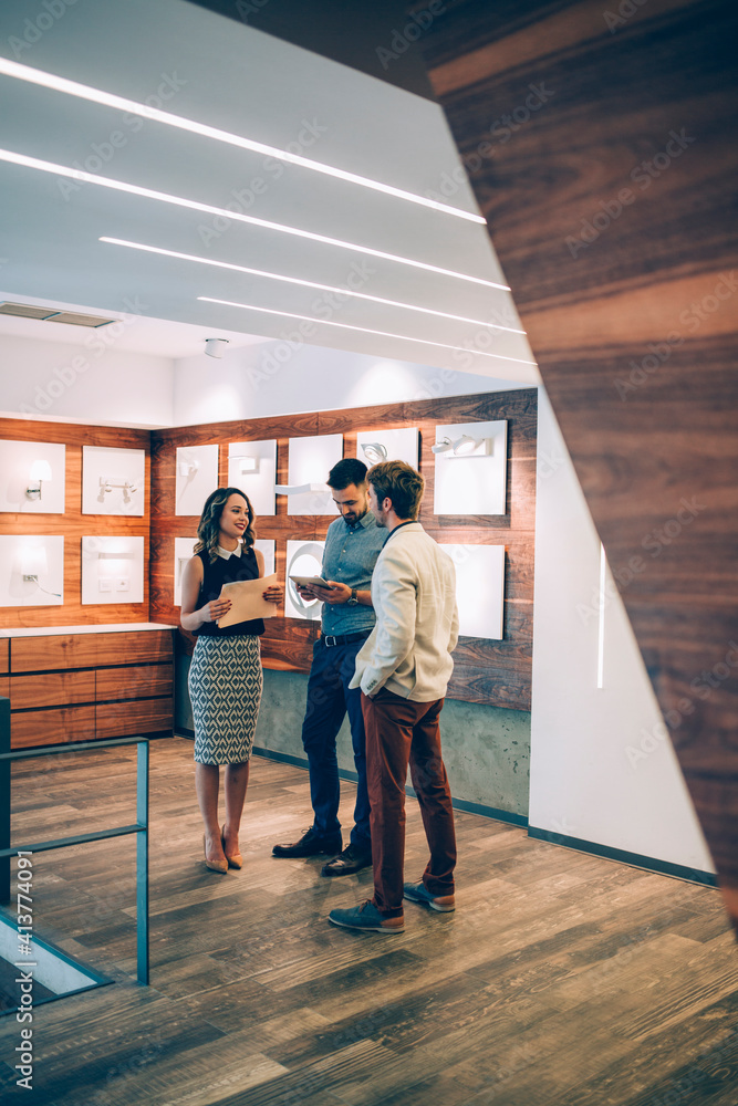 Happy business people discussing while standing in office Happy business people discussing while standing in office