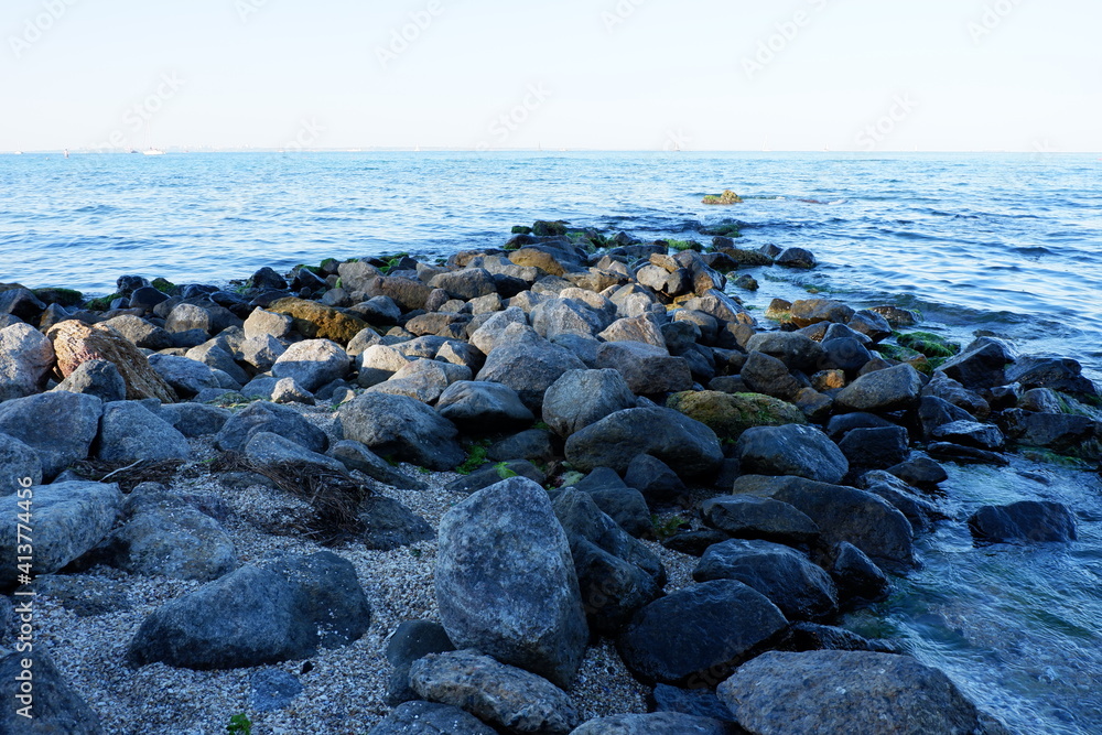Seascape. Rocky seashore. Pile of stones in the sea Seascape. Rocky seashore. Pile of stones in the sea