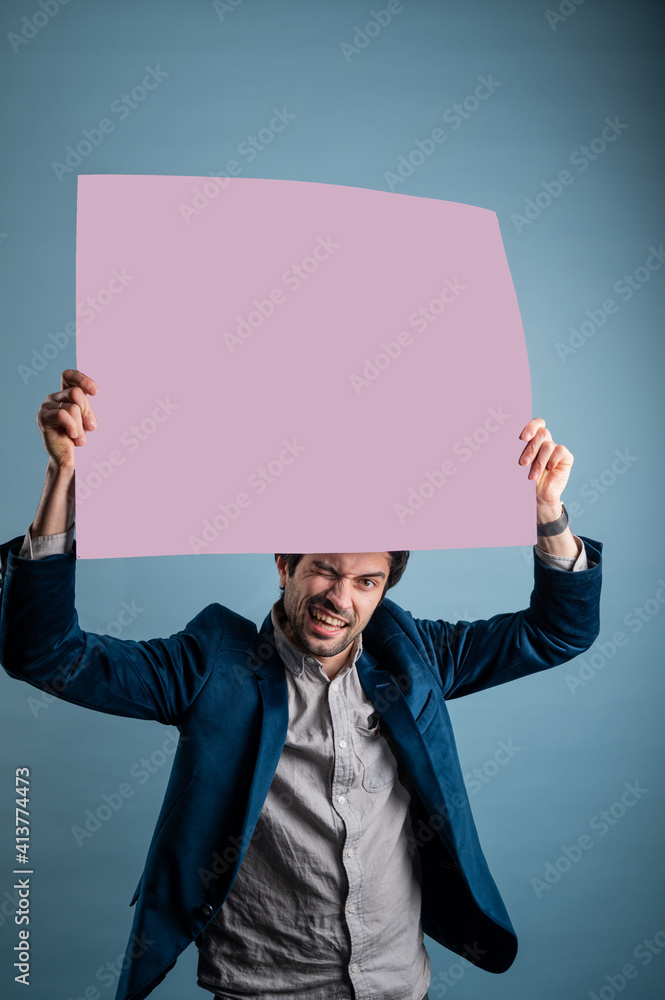 Happy smiling man showing blank signboard with empty copyspace area for slogan or advertising text message. Happy smiling man showing blank signboard with empty copyspace area for slogan or advertising text message.