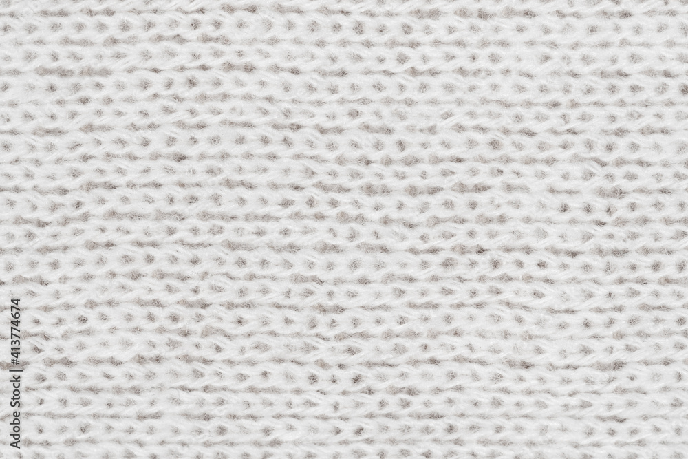 White natural texture of knitted wool textile material background. White crochet cotton fabric woven canvas texture. close up White natural texture of knitted wool textile material background. White crochet cotton fabric woven canvas texture. close up
