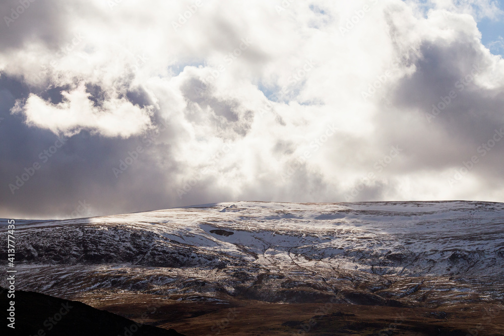 Scenic view of snowcapped mountain against cloudy sky Scenic view of snowcapped mountain against cloudy sky