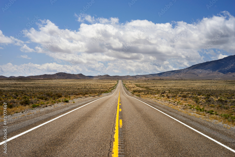 Country road amidst field against cloudy sky Country road amidst field against cloudy sky