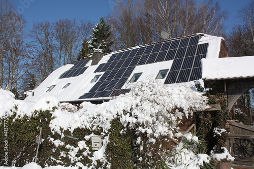 Photovoltaikanlage im Winter zum Teil mit Schnee bedeckt