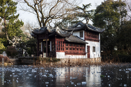 Traditional Chinese building with by a frozen pond