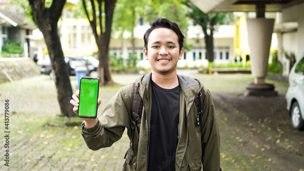 Asian man wearing green screen cellphone