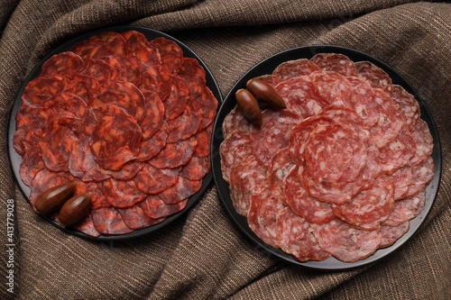 Servings of chorizo and 100% acorn-fed Iberian salchichón from Extremadura decorated with acorns photo