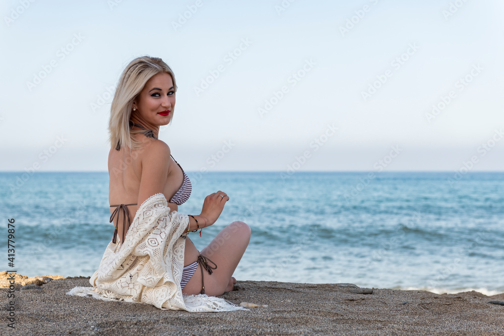 Looking at the camera while relaxing on the beach. High quality photo Looking at the camera while relaxing on the beach. High quality photo