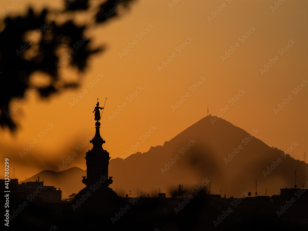 Beautiful sunset in Bilbao, city of the Basque country, with the silhouette of the church of San Anton and Mount Serantes.