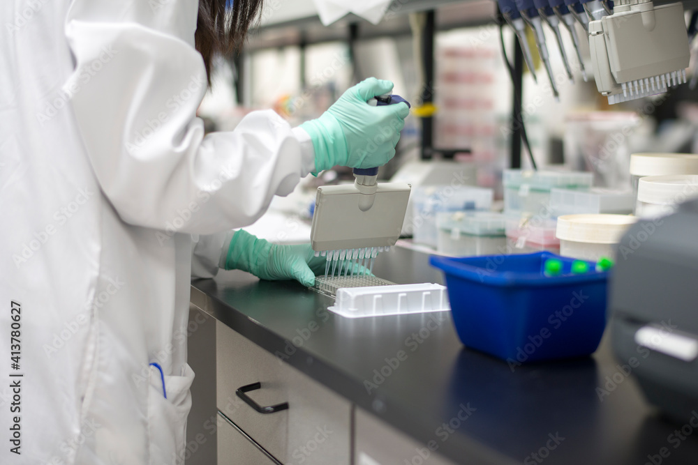 Midsection of scientist working in laboratory Midsection of scientist working in laboratory