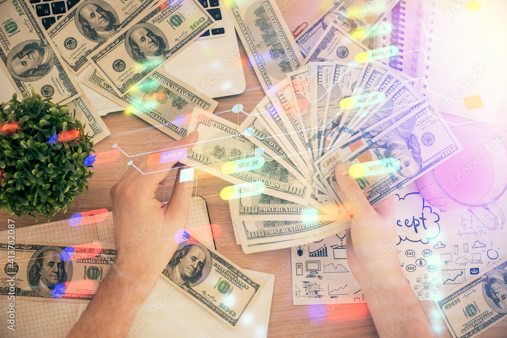 Multi exposure of technology drawing hologram and us dollars bills and man hands. Data concept