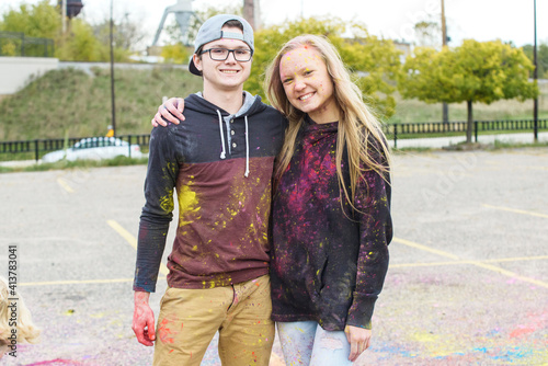 Wallpaper Mural Portrait of happy friends with powder paint standing on footpath at park Torontodigital.ca