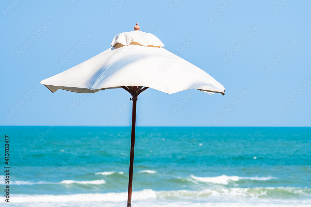 Umbrella and chair around sea beach ocean with coconut palm tree