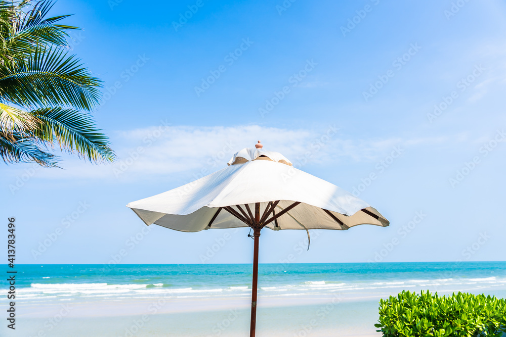 Umbrella and chair around sea beach ocean with coconut palm tree