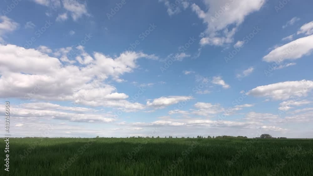 Clear sky over emerald green field. Time Lapse: Green fields with cloud moving and blue sky.
Clear sky over emerald green field. Time Lapse: Green fields with cloud moving and blue sky.