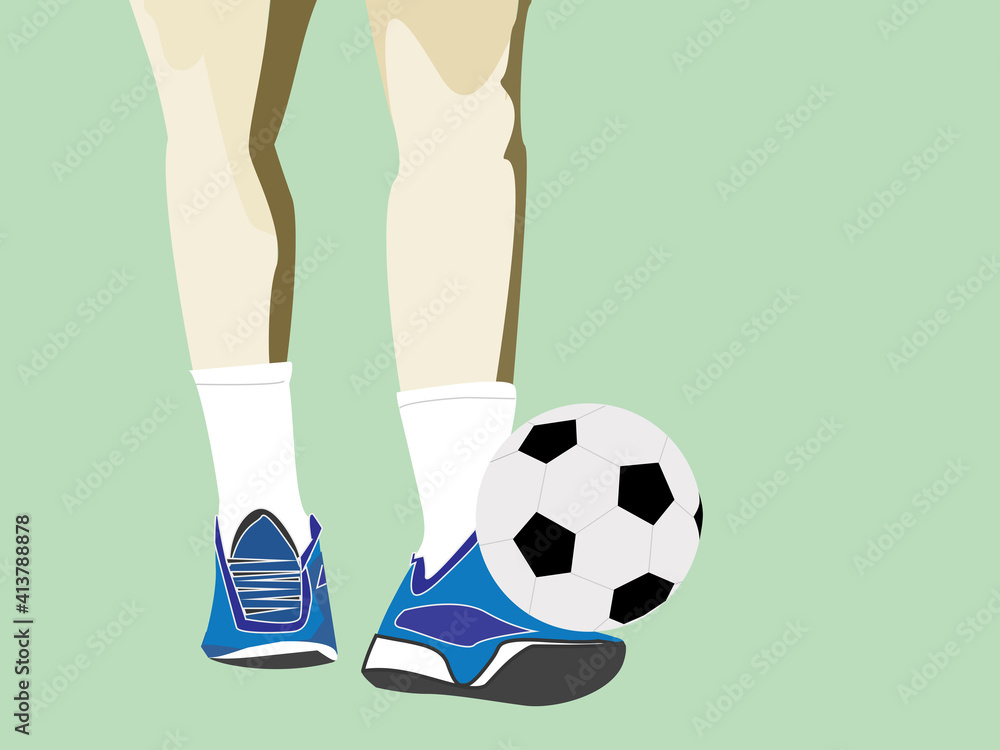 Men's feet and soccer ball on green field