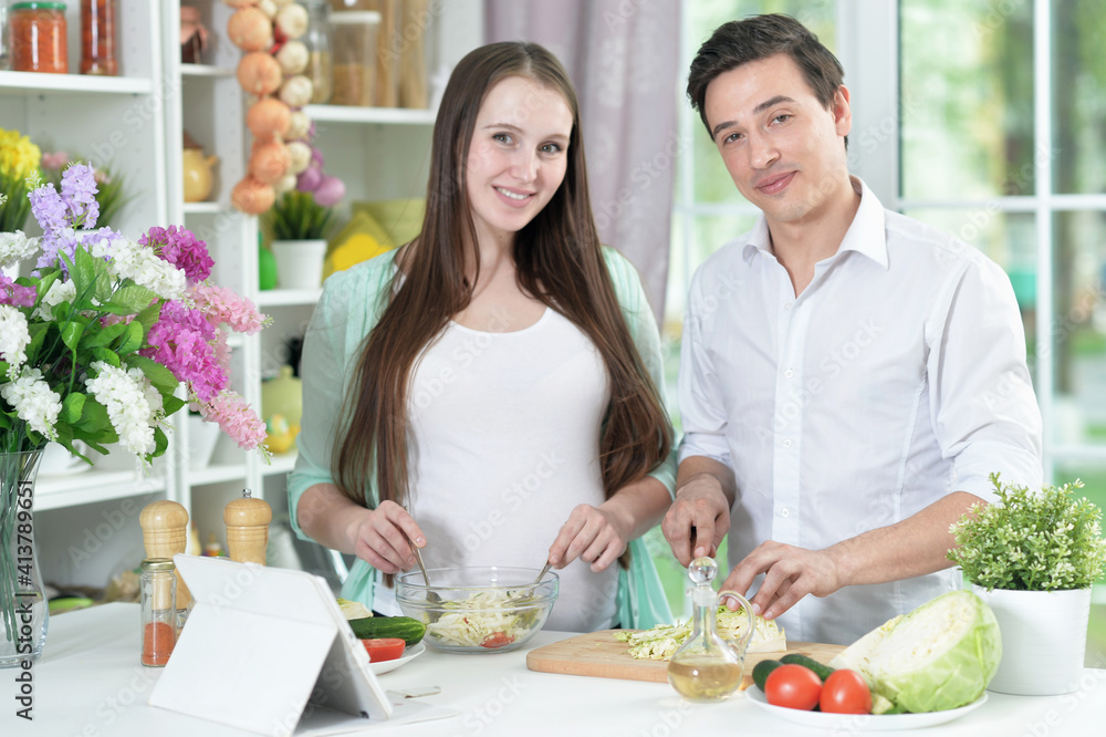 Happy husband and wife cooking together in the kitchen Happy husband and wife cooking together in the kitchen