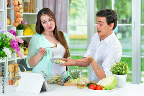 Happy husband and wife cooking together