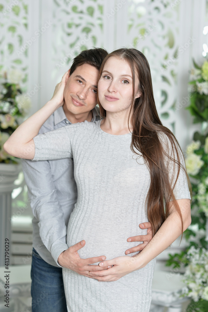 happy pregnant woman with husband posing at home happy pregnant woman with husband posing at home