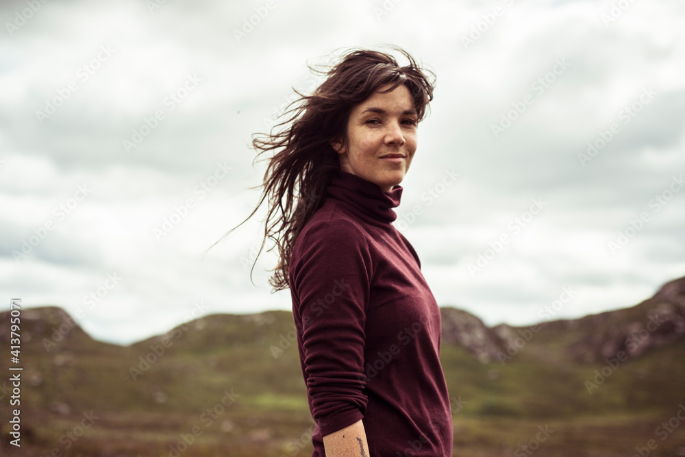 young woman hiking in the Scottish countryside young woman hiking in the Scottish countryside