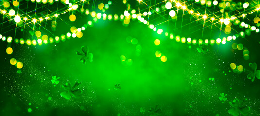 St. Patrick's Day abstract green background decorated with shamrock leaves. Patrick Day pub party celebrating. Abstract Border art design magic backdrop. Widescreen clovers on black with copy space