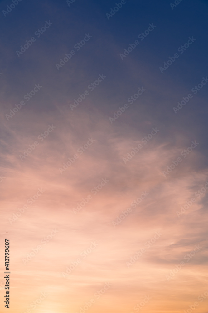 Sunset sky vertical background with colorful orange sunlight in the evening, dusk sky background. 