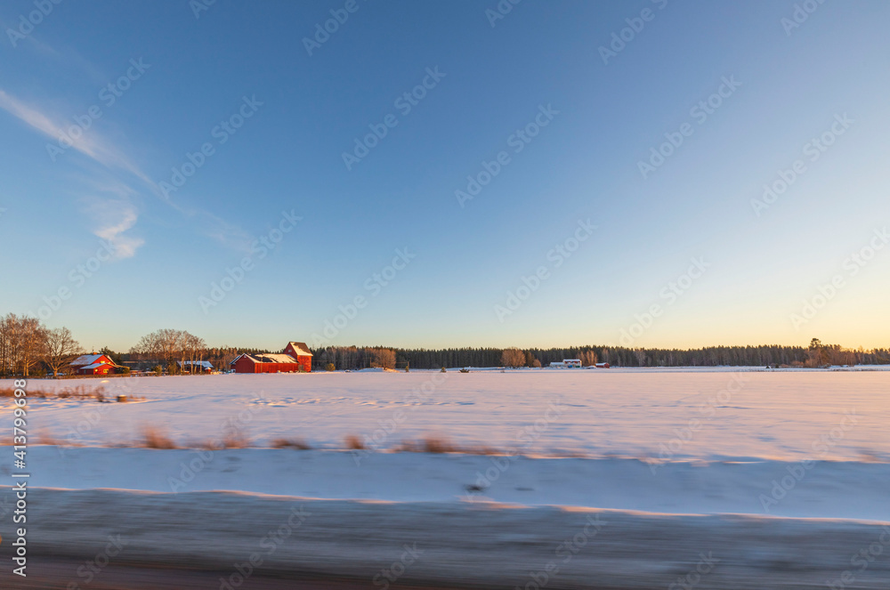 Beautiful nature landscape view on winter day. Field merging with blue sky and white clouds. Beautiful winter background. Sweden. Beautiful nature landscape view on winter day. Field merging with blue sky and white clouds. Beautiful winter background. Sweden.