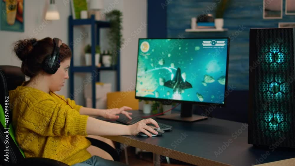 Back shot of happy gamer playing and winning space shooter online video game on powerful personal computer. Online streaming cyber performing during gaming tournament using technology network wireless Back shot of happy gamer playing and winning space shooter online video game on powerful personal computer. Online streaming cyber performing during gaming tournament using technology network wireless